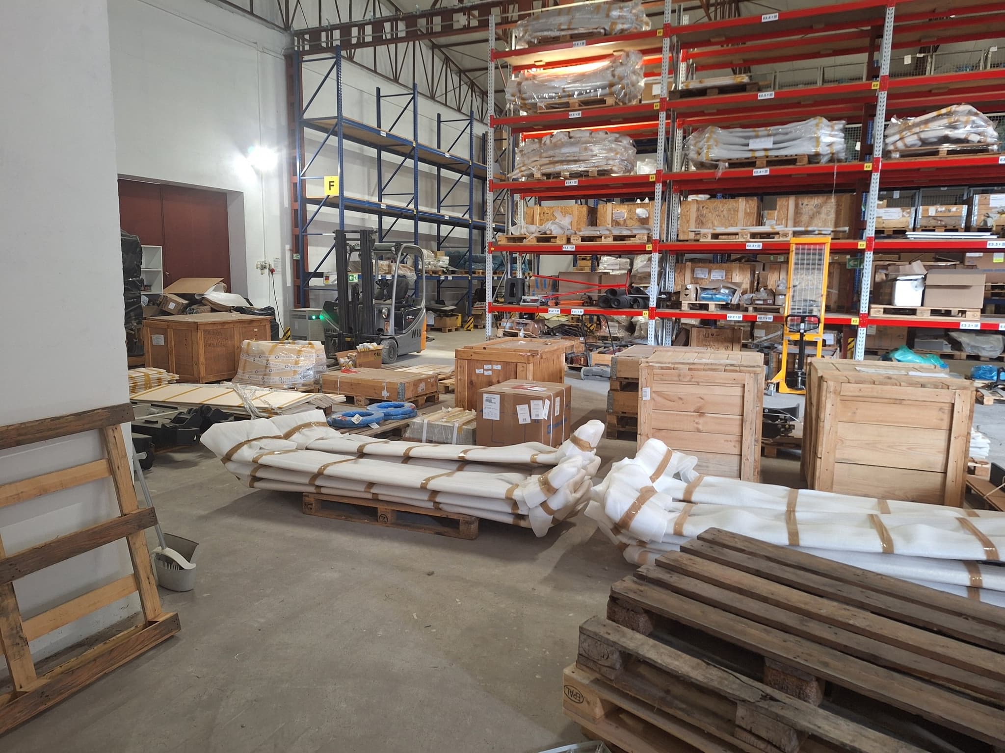 Wrapped and banded rail components on pallets awaiting cross-border shipment